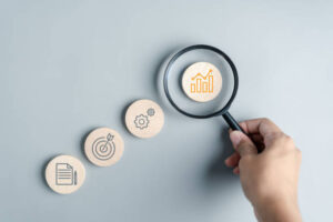 Hand holding magnifier to analysis portfolio management.